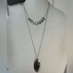 Four long silvertone statement necklaces